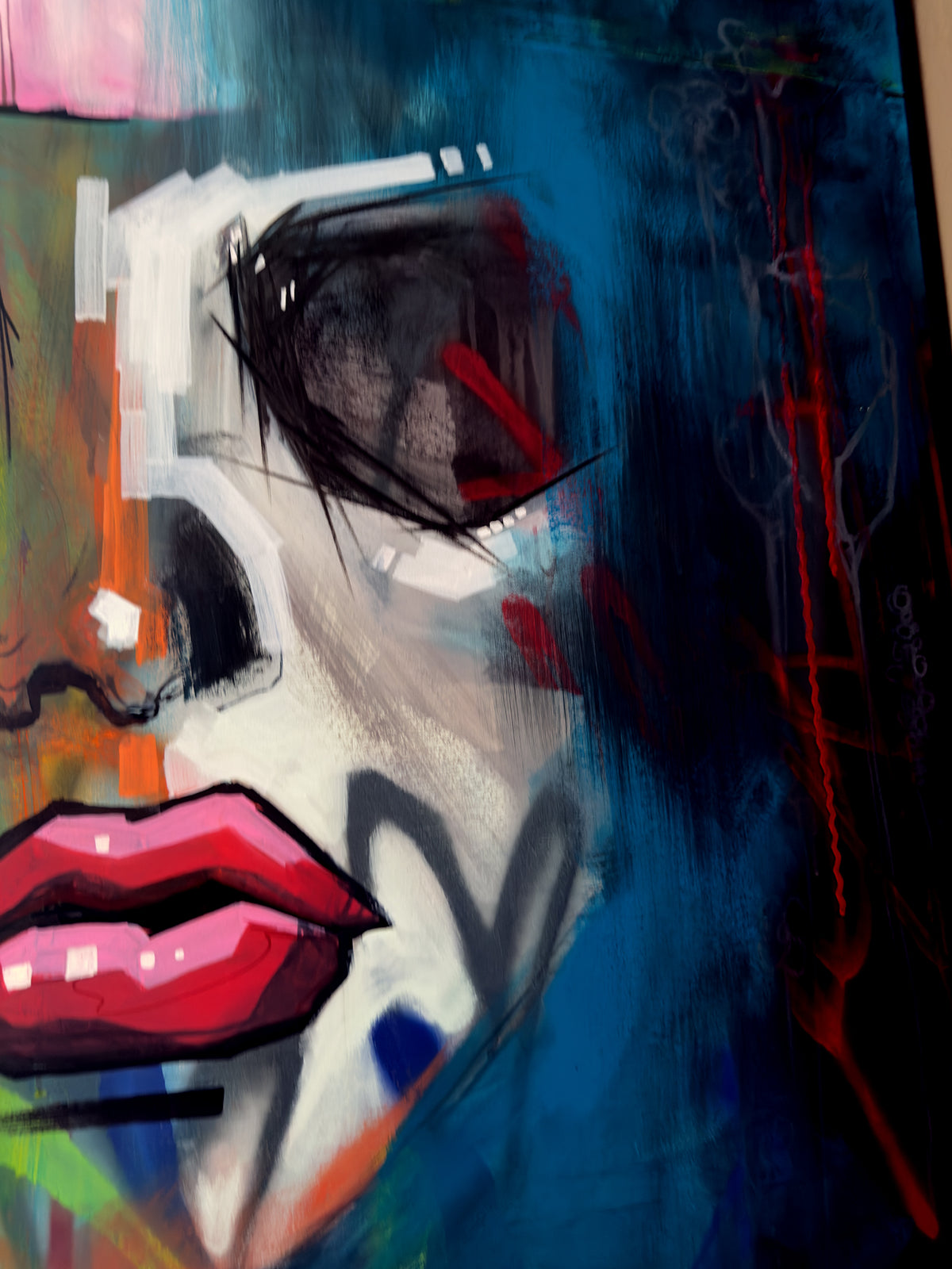 Amani detail: the shadow-self side of her face and red linework